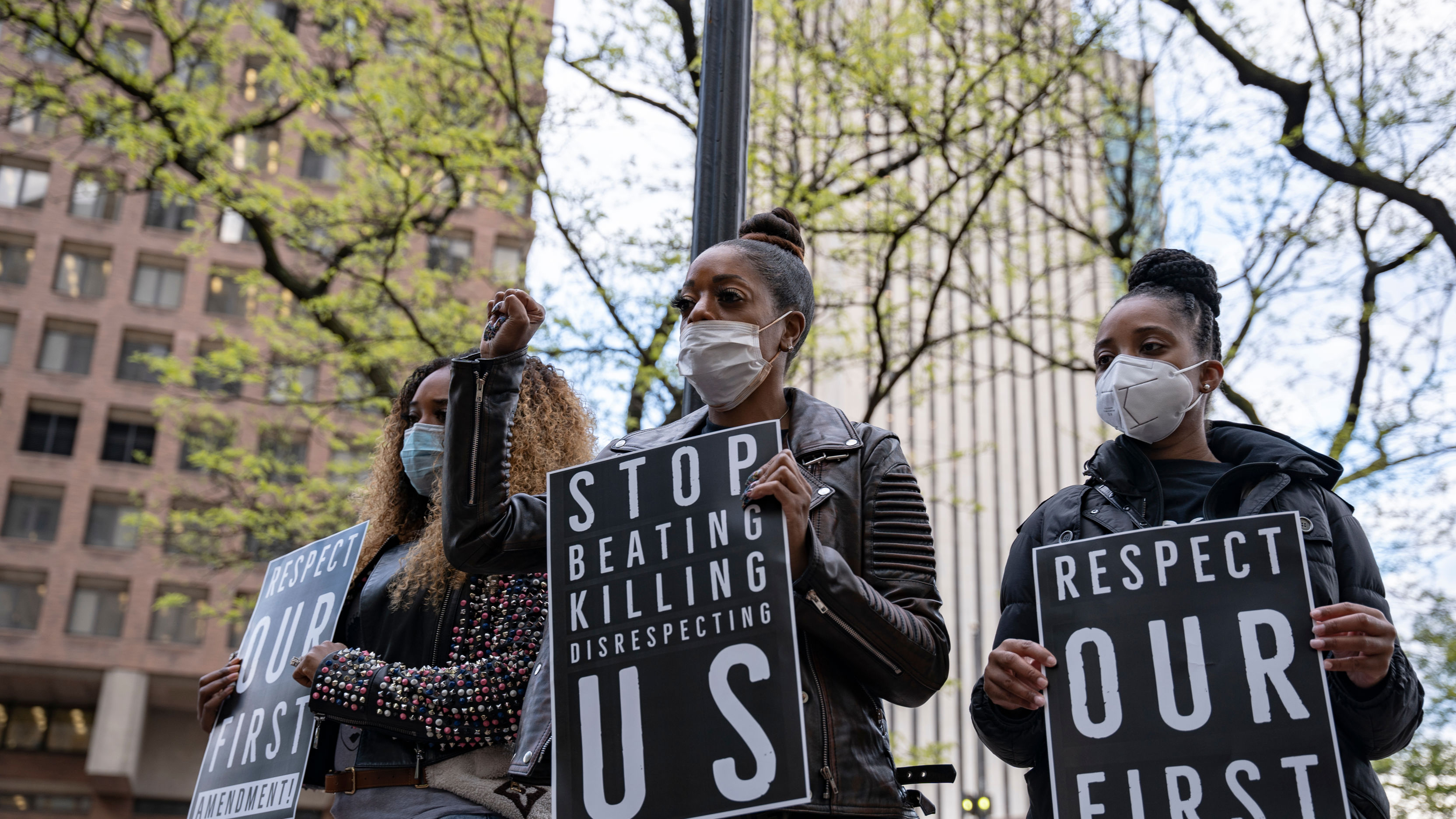 Protestors in Manhattan, New York hold up signs advocating for an end to police brutality against Black Americans.